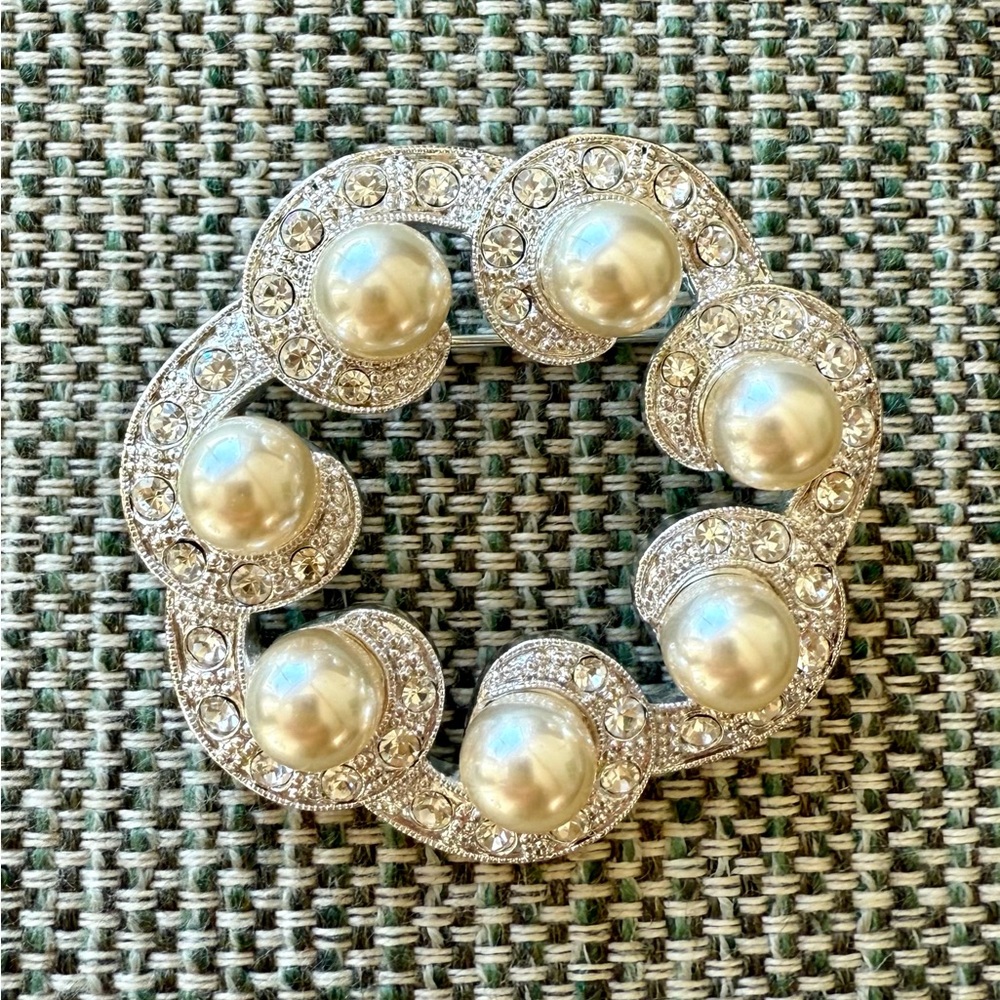 Simulated Pearls and Rhinestones in a silver color setting.